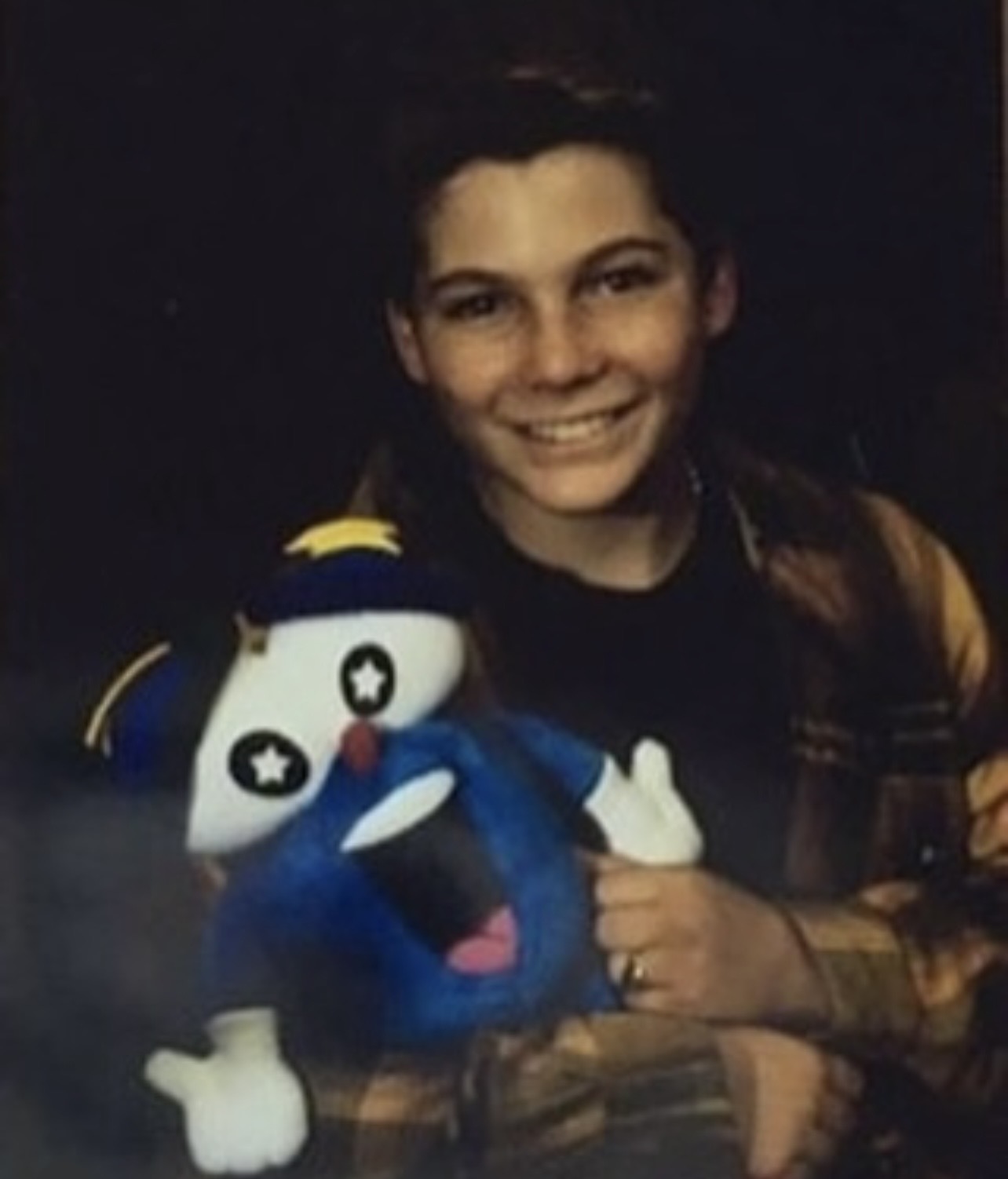 Young Justin Shenkarow holding Izzy stuffed animal
